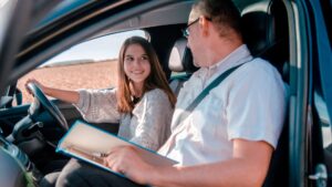 girl driving a car and an instructor giving instructions