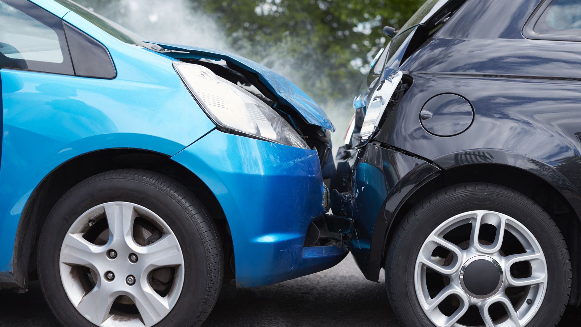 Two cars collided, showing front-end damage.