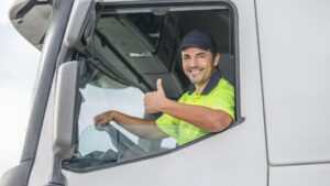 a truck driver smiling on front of camera