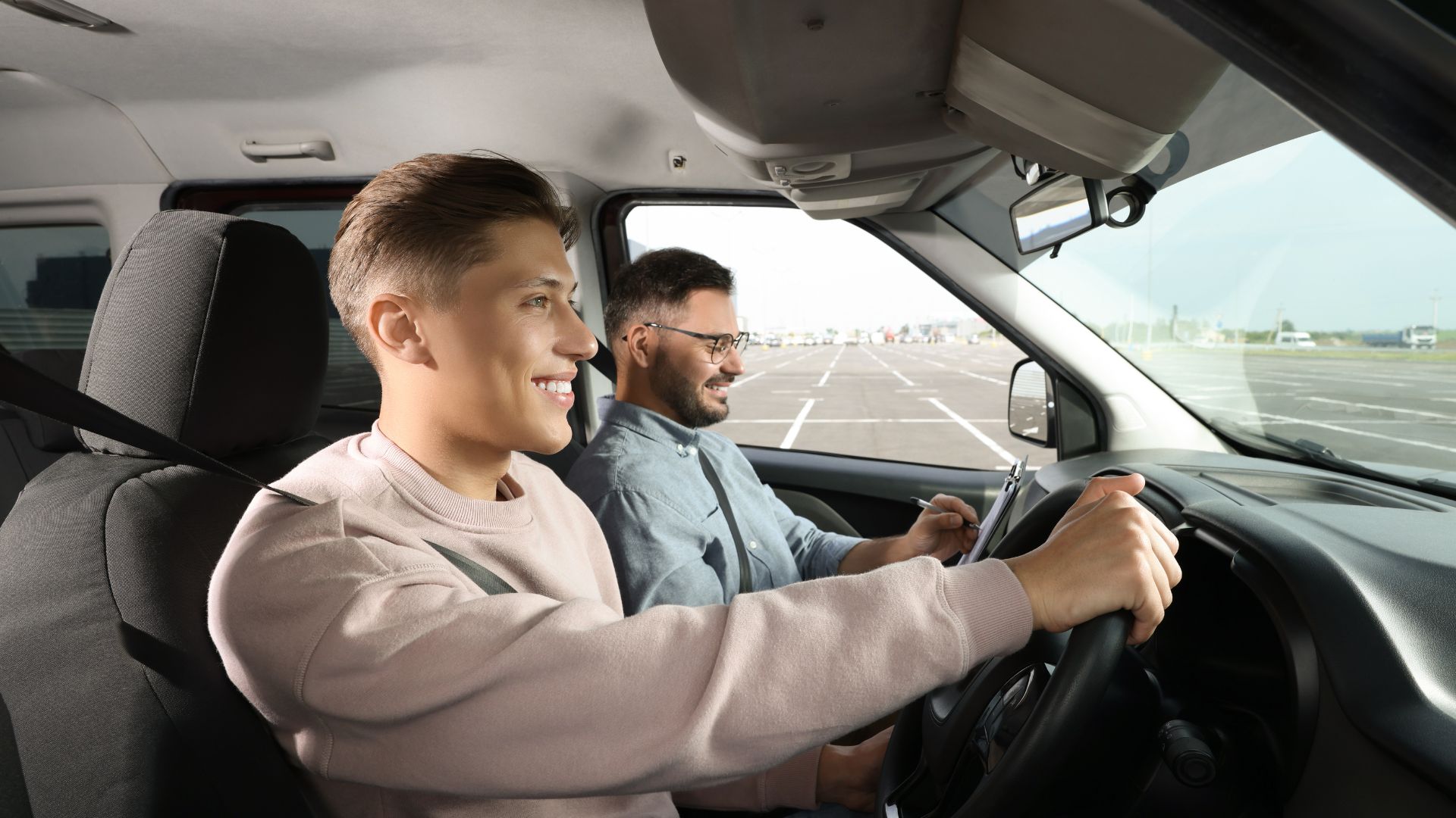 a person smiling and driving a car