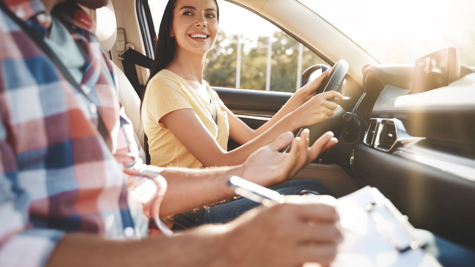 a girl driving a car and smiling