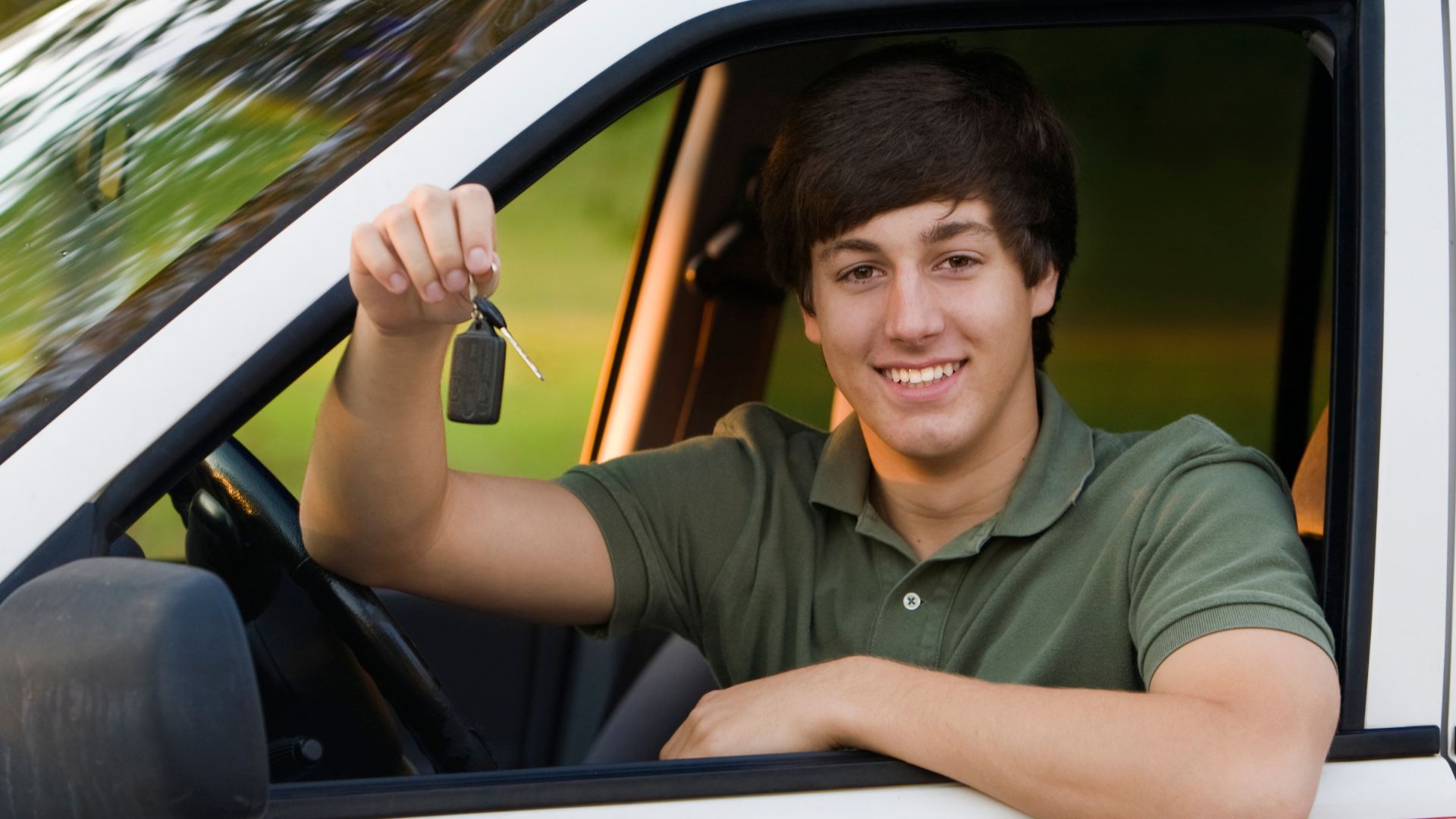 a boy holding key and smiling