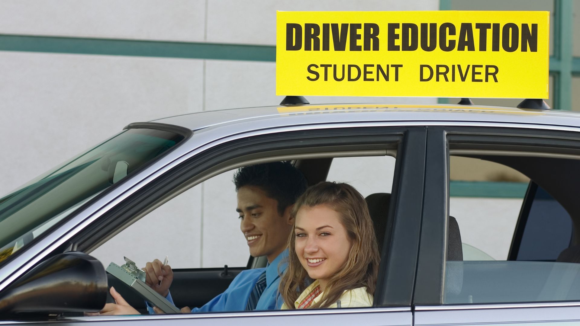 driver education student driver and girl smiling