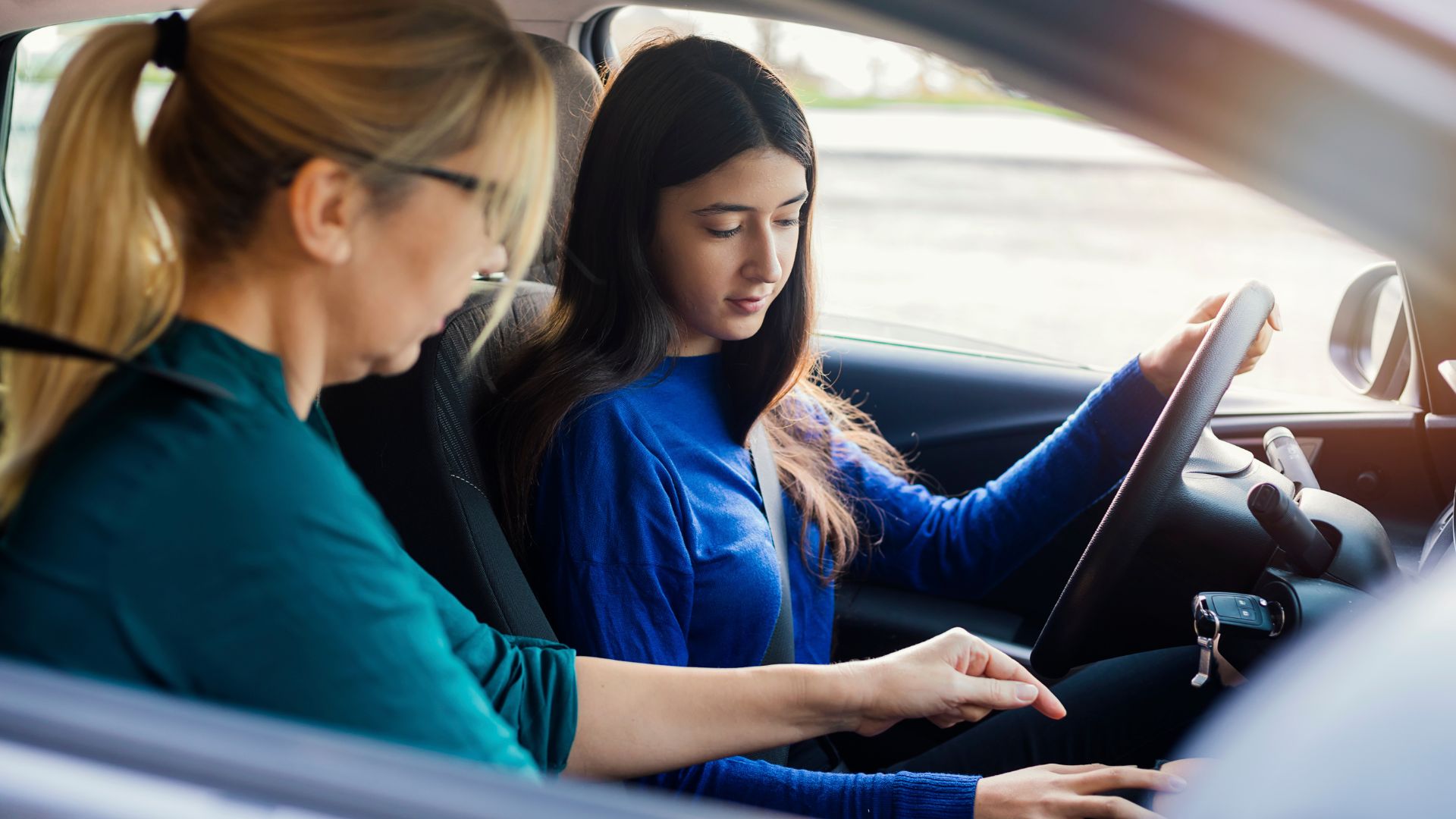 girl learning to drive a car